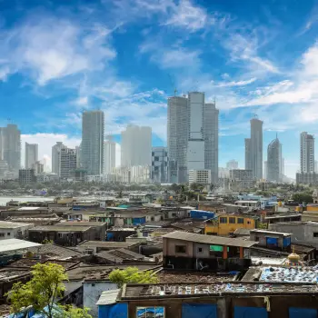 Views of slums on the shores of Mumbai, India against the backdrop of skyscrapers under construction.
